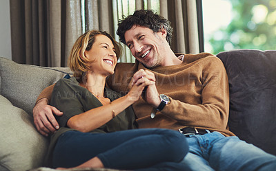 Buy stock photo Shot of an affectionate mature couple relaxing on the sofa at home