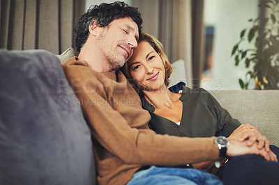 Buy stock photo Shot of an affectionate mature couple relaxing on the sofa at home