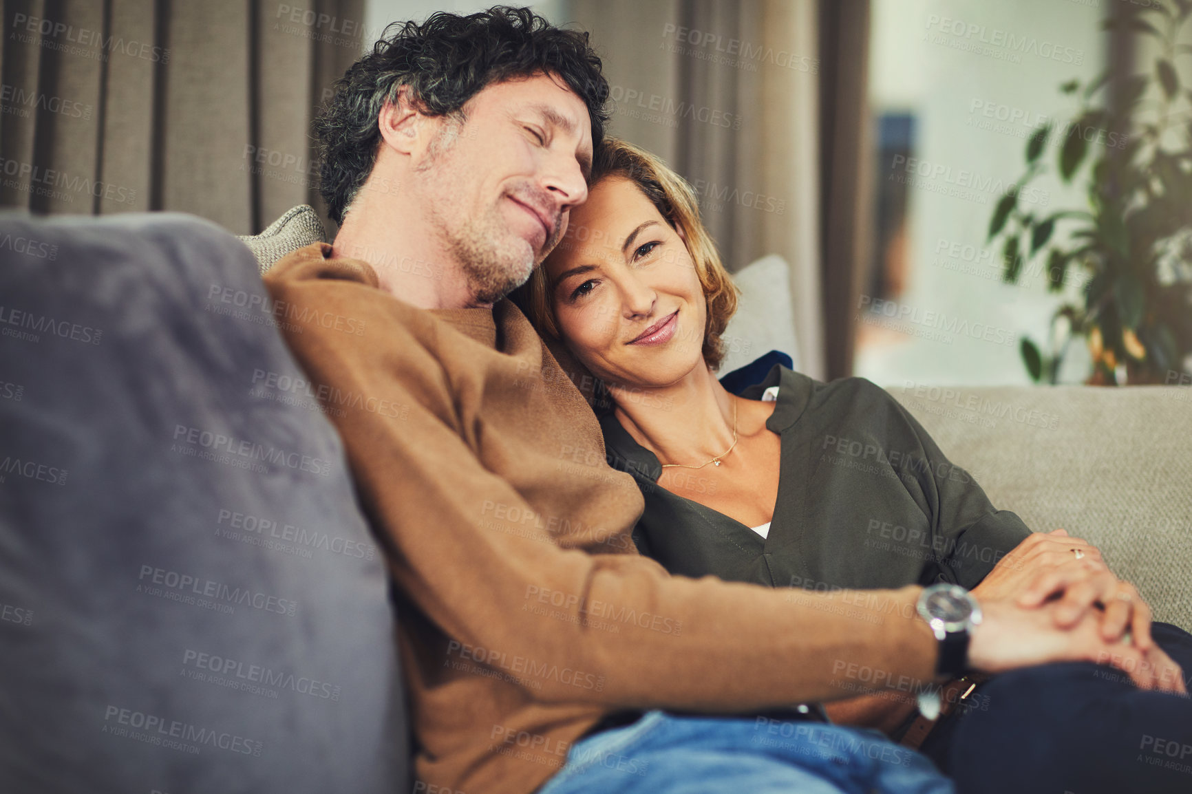 Buy stock photo Couple, calm and relax on sofa together for connection, commitment and relationship security. Portrait, mature woman and man with hug, cuddle or affection on weekend break, moment or care in home
