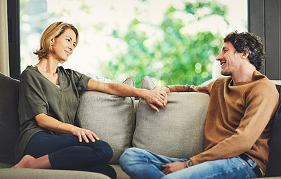 Buy stock photo Shot of a mature couple relaxing and chatting on the sofa at home