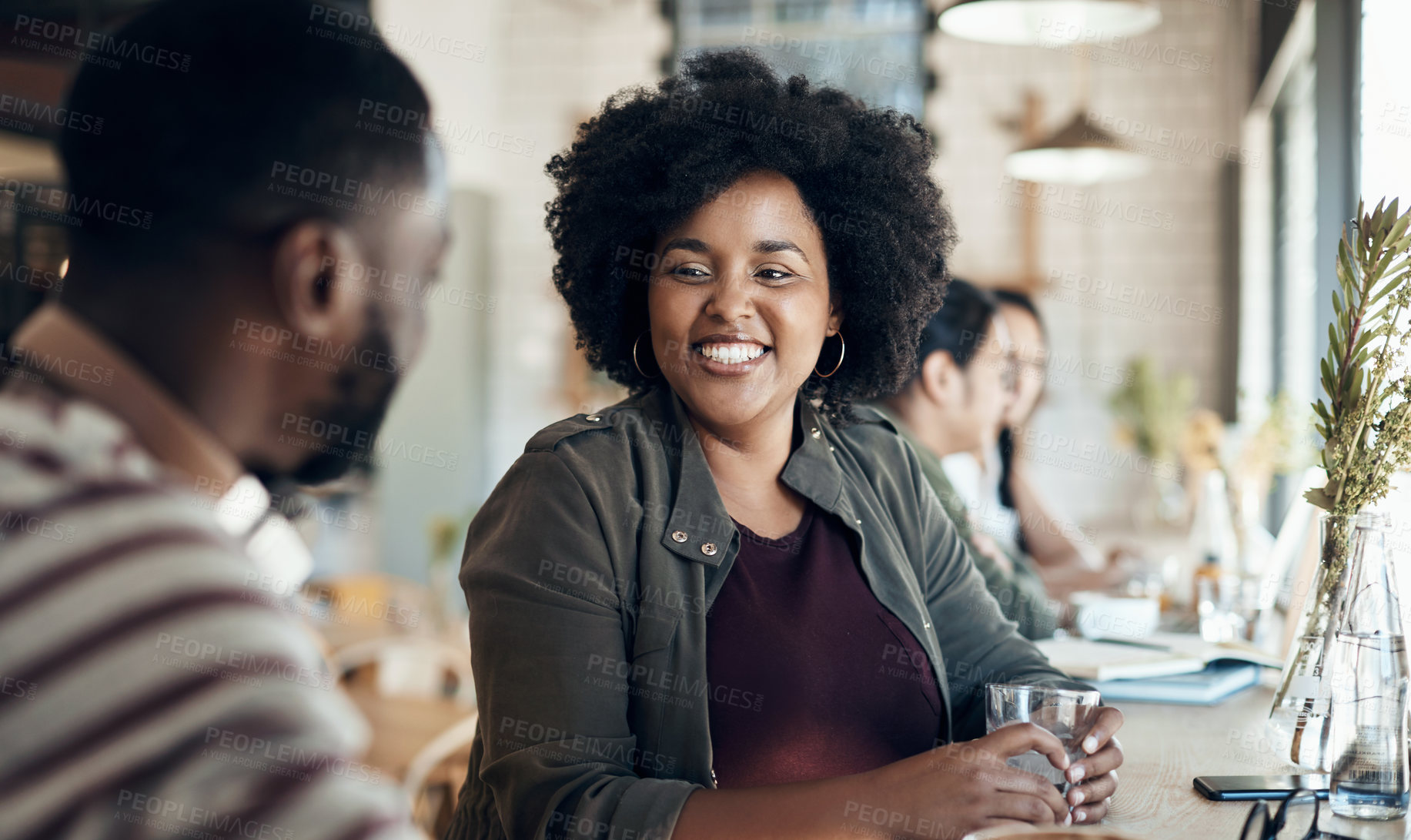 Buy stock photo Cropped shot of an attractive young woman sitting with a male friend in a cafe during the day