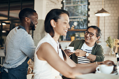 Buy stock photo Cropped shot of a handsome young businessman sitting with a female colleague and getting a coffee in a cafe
