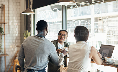 Buy stock photo Cropped shot of a handsome young businessman sitting with a female colleague and getting a coffee in a cafe