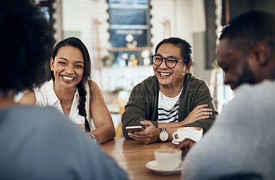 Buy stock photo Cropped shot of a young group of friends sitting together and bonding in a cafe during the day