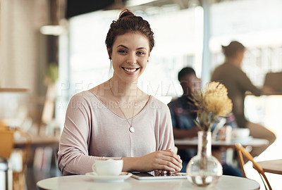 Buy stock photo Cropped shot of an attractive young woman sitting on her own in a cafe during the day