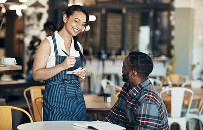 Buy stock photo Cropped shot of an attractive young waitress taking down an order for a male customer in the cafe