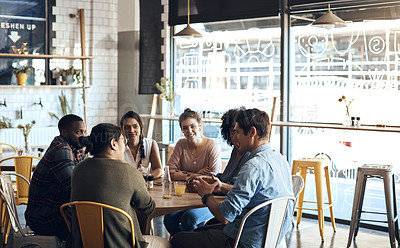 Buy stock photo Cropped shot of a diverse group of businesspeople sitting together and having a discussion in a coffee shop