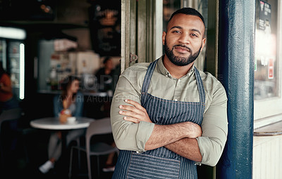 Buy stock photo Portrait of a young man standing at the doorway of his cafe