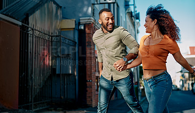 Buy stock photo Shot of a young couple walking together in the city