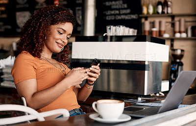 Buy stock photo Shot of a young woman using a cellphone in a cafe