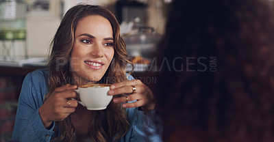 Buy stock photo Shot of a young woman chatting to her friend in a cafe