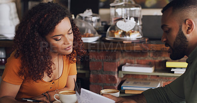 Buy stock photo Shot of a young man and woman having a meeting in a cafe