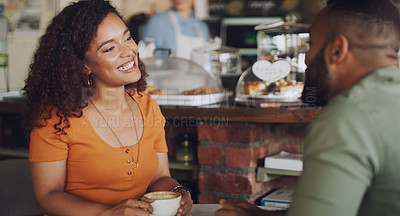 Buy stock photo Shot of a young couple chatting in a cafe