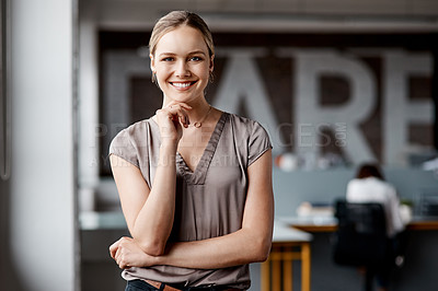 Buy stock photo Shot of an attractive young businesswoman standing alone in the office during the day
