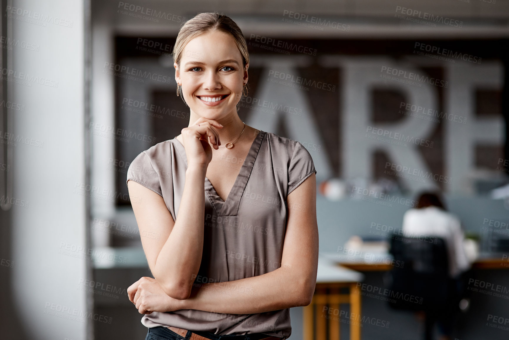 Buy stock photo Shot of an attractive young businesswoman standing alone in the office during the day