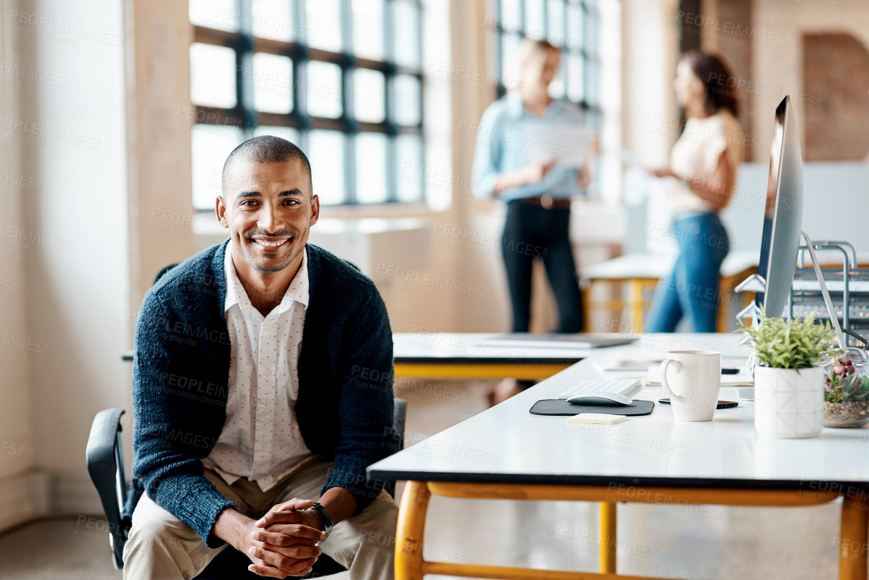 Buy stock photo Portrait of a confident young businessman working in an office