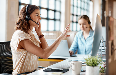 Buy stock photo Shot of a young businesswoman wearing a headset while working on a computer in an office