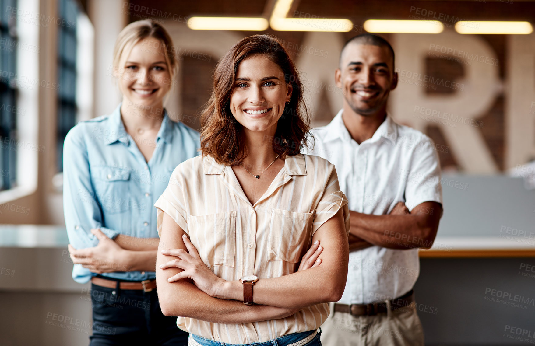 Buy stock photo Woman, leader and team with smile at office, professional portrait and about us at publishing firm. Person, editor in chief and group with arms crossed, mission or ambition with creative partners 