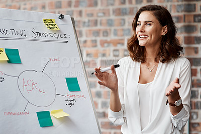 Buy stock photo Shot of a young businesswoman presenting notes on a whiteboard in an office