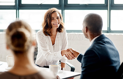 Buy stock photo Shot of businesspeople shaking hands in an office
