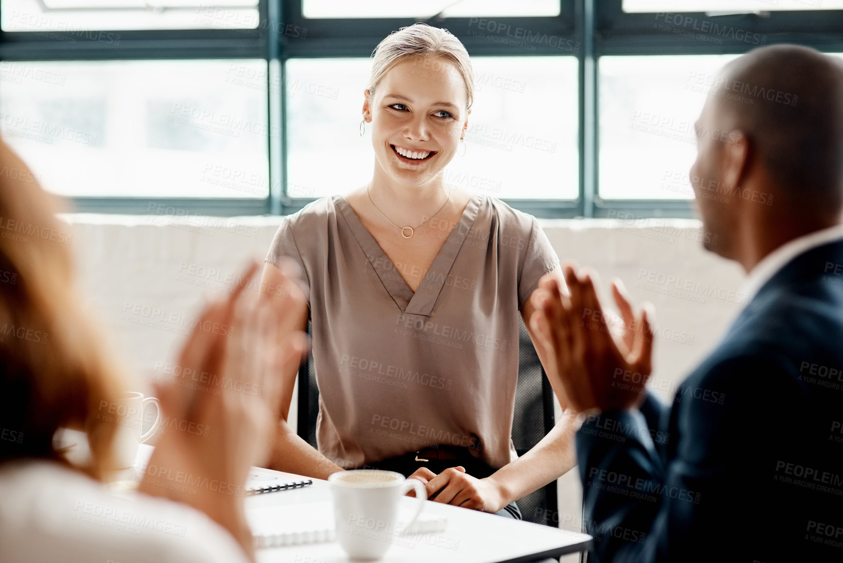Buy stock photo Shot of a young businesswoman receiving applause during a meeting in an office