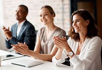 Buy stock photo Shot of a group of businesspeople applauding during a meeting in an office