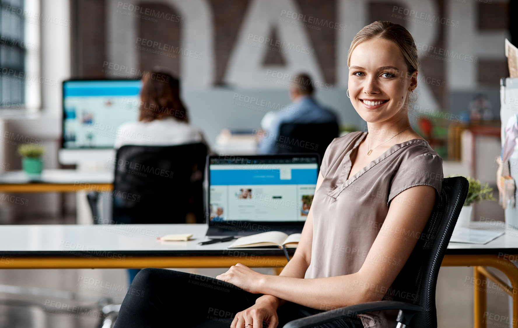 Buy stock photo Portrait of a confident young businesswoman working in an office