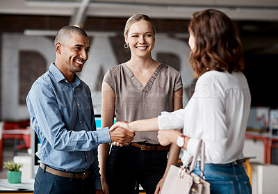 Buy stock photo Shot of businesspeople shaking hands in an office
