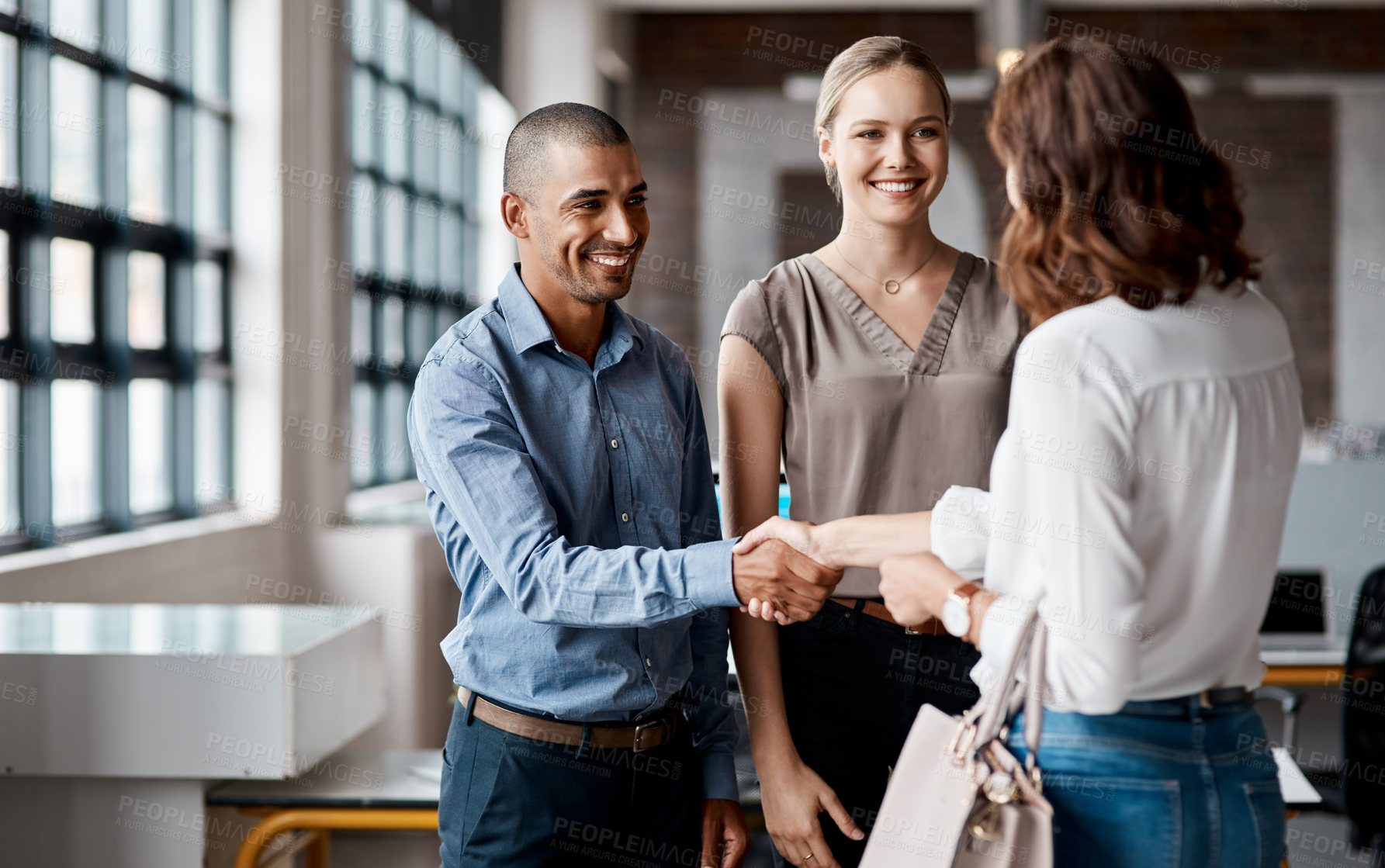 Buy stock photo Shot of businesspeople shaking hands in an office