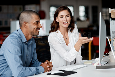 Buy stock photo Shot of two businesspeople working together on a computer in an office