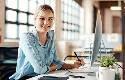Buy stock photo Portrait of a young businesswoman using a computer in a modern office