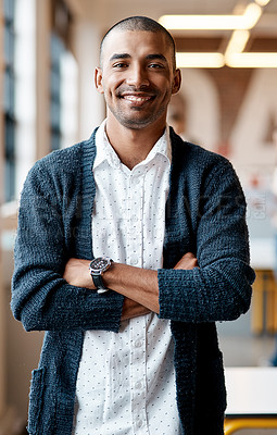 Buy stock photo Portrait of a confident young businessman working in a modern office