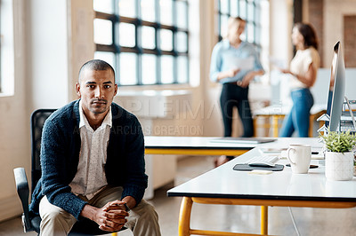 Buy stock photo Shot of a young businessman using a computer in a modern office