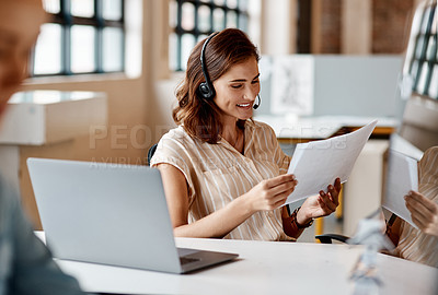 Buy stock photo Shot of a young woman using a headset and laptop in a modern office