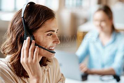 Buy stock photo Shot of a young woman using a headset in a modern office