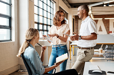 Buy stock photo Shot of a group of young businesspeople having a meeting in a modern office