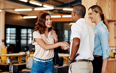 Buy stock photo Shot of a young businesswoman shaking hands with a colleague during a meeting in a modern office