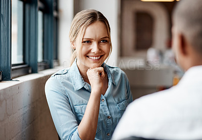 Buy stock photo Shot of a young businesswoman having a discussion with a colleague in a modern office