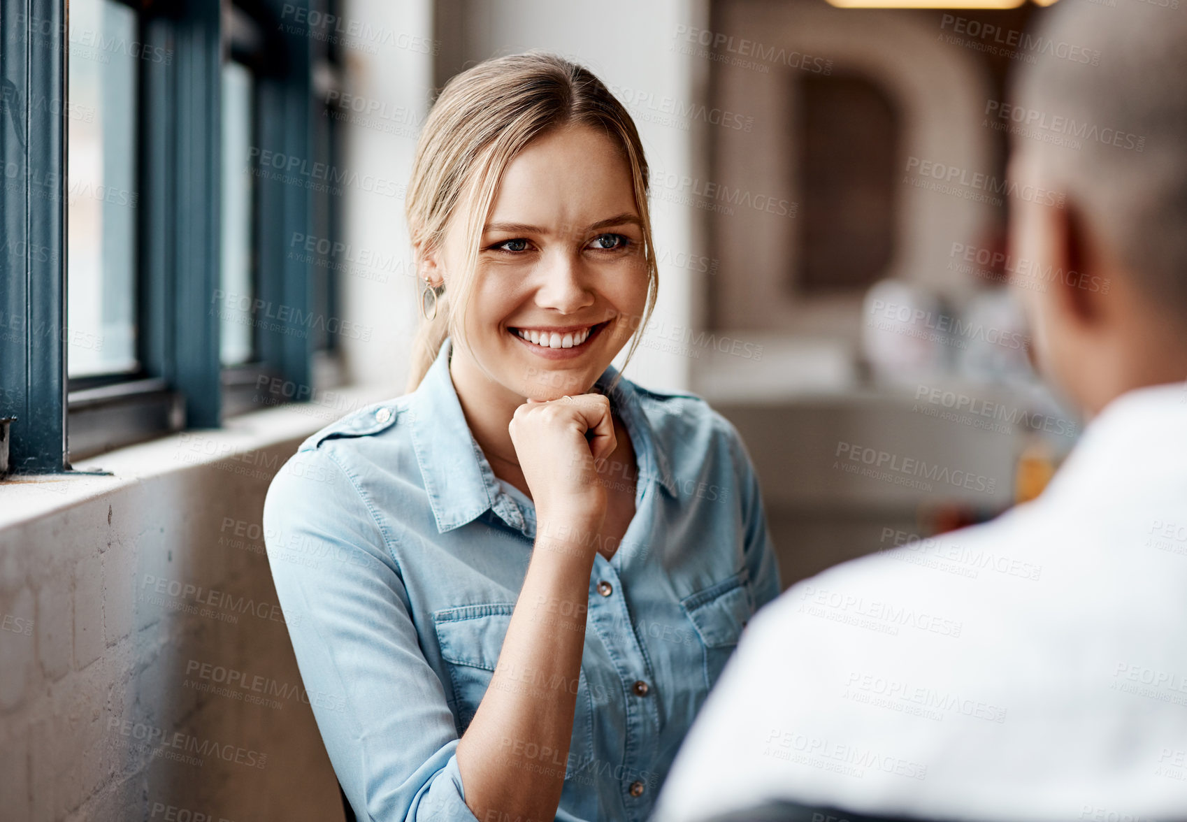 Buy stock photo Shot of a young businesswoman having a discussion with a colleague in a modern office