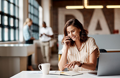 Buy stock photo Shot of a young businesswoman using a laptop and smartphone in a modern office