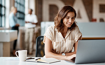 Buy stock photo Shot of a young businesswoman using a laptop in a modern office