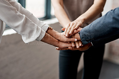Buy stock photo Closeup shot of a group of unrecognisable businesspeople joining their hands together in a huddle