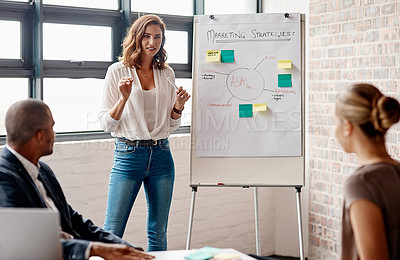 Buy stock photo Shot of a young businesswoman giving a presentation to her colleagues in an office