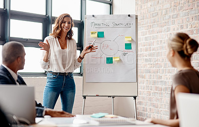 Buy stock photo Shot of a young businesswoman giving a presentation to her colleagues in an office