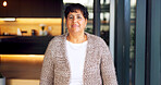 Portrait, smile and senior woman in home with confidence, comfort or positive attitude in retirement. Happy, female homeowner and weekend break in living room to relax, laugh and wellness in house