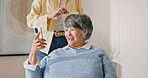Phone, hairdresser and senior woman in home for styling, grooming or cosmetic treatment. Cellphone, happy and stylist with elderly person for hair care routine with texting, chatting or social media.