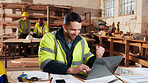 Excited, carpenter and man with laptop in factory, fist pump and design approval on web and success. Woodworking, person and celebration for project, achievement and good news on computer in workshop