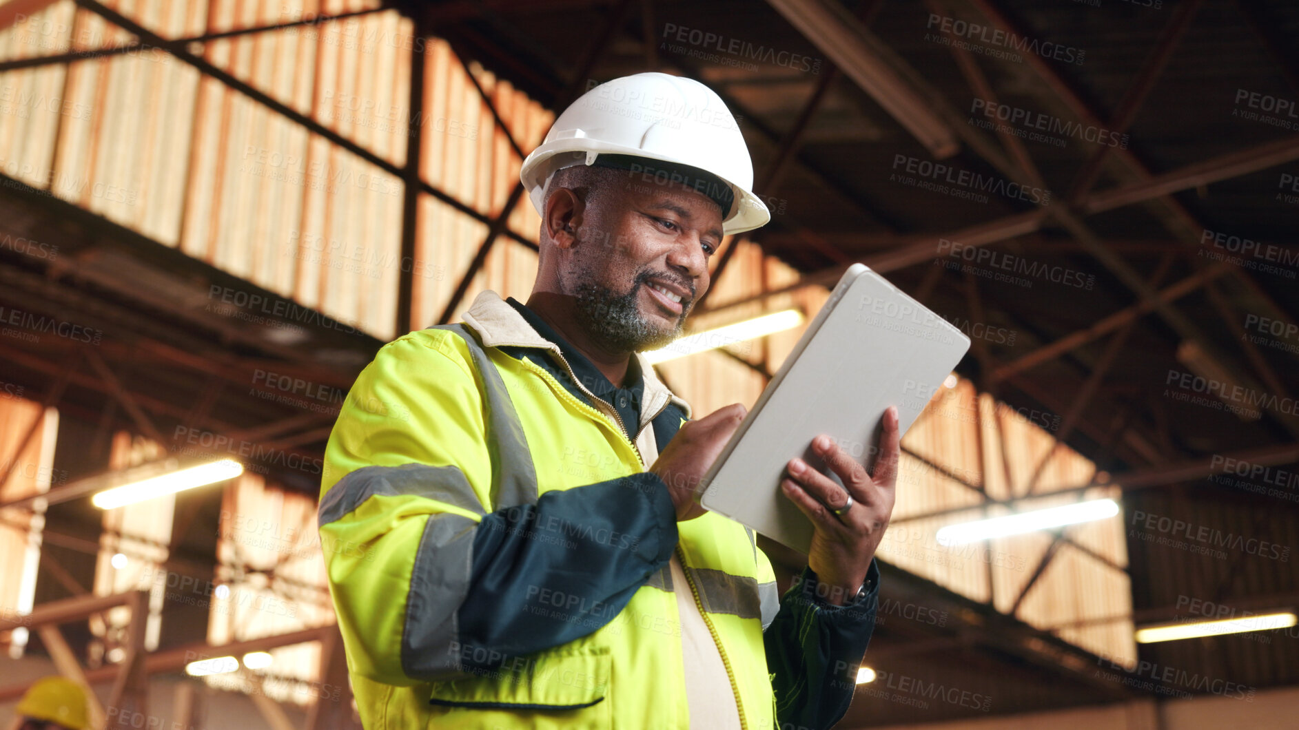 Buy stock photo Architect, scroll and happy man with tablet on construction site, research and property development. Mature civil engineer, low angle and black person with tech, online or building renovation on web