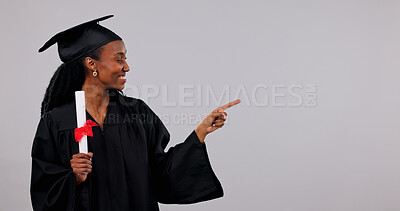 Buy stock photo Graduation, pointing and space with black woman in studio for education, empowerment or information. Diploma, learning and university sign up with happy student on white background for scholarship