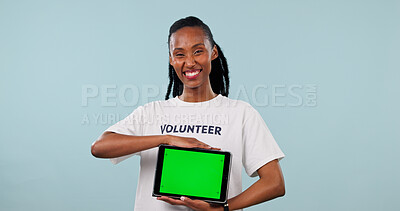 Buy stock photo Portrait, volunteer or black woman with tablet green screen for NGO on a studio background. Happy, female person or helper with smile or technology display for app or charity campaign on mockup space